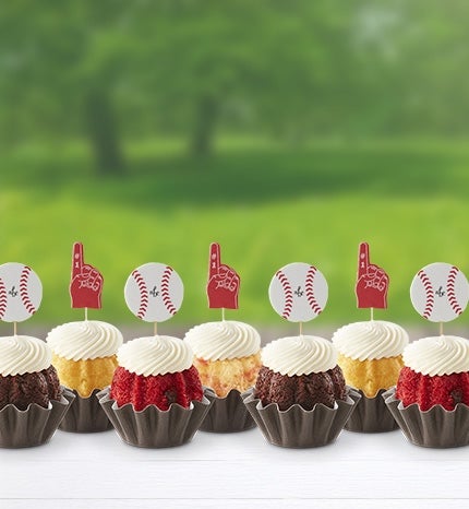 Bundtinis with baseball and glove toppers on a table