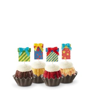 Four Bundtinis sitting in a row. Each has a birthday present topper sticking out from the middle.