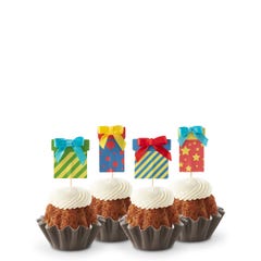 Cupcake-sized mini cakes with frosting and birthday present toppers with different celebratory designs.