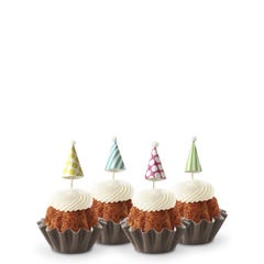 Dotted party hats top the frosting covered mini bundt cakes.