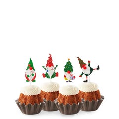 Carrot mini bundt cakes topped with four Christmas-themed gnome decorations: one in green with a mistletoe, one in red with a tree, one in stripes with a gift, and one in red and white.