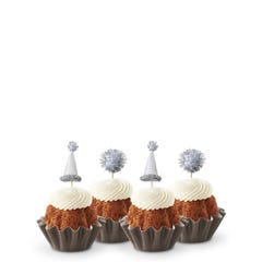 Carrot mini Bundt cakes (Bundtinis®) each topped with creamy white frosting and adorned with silver party hats and matching silver pom-poms.