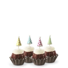 Dotted party hats top the frosting covered mini bundt cakes.