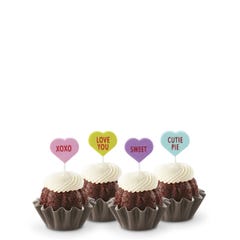 Mini Bundt cakes with white frosting, topped with conversation hearts in pink, lime, lavender, and light teal, displaying messages: XOXO, LOVE YOU, SWEET, and CUTIE PIE.