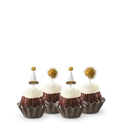 Mini Bundt cakes adorned with festive party hat toppers and golden pom-poms themed for a New Year's celebration.