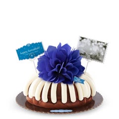 Hanukkah decorated bundt cake with an indigo colored bow.
