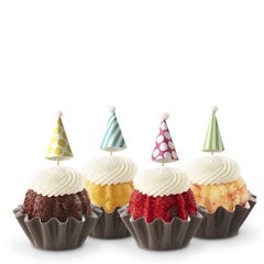 Dotted party hats top the frosting covered mini bundt cakes.