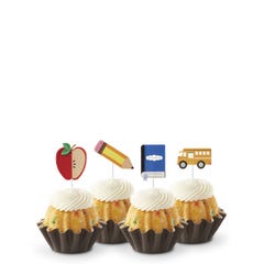 Confetti flavored mini Bundt cakes (Bundtinis®) topped with creamy white frosting, accompanied by school-themed toppers: a sliced apple, a pencil, a notebook, and a yellow school bus.