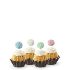 Cupcake-sized Bundt cakes topped with creamy white frosting. Each has a fluffy pom-pom topper in shades of sky blue, white, mint green, and soft rose.