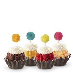 Cupcake sized bundt cakes in a variety of flavors with a pom pom topper. 