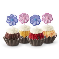 Bundtinis® topped with frosting and decorated with purple and pink flowers.