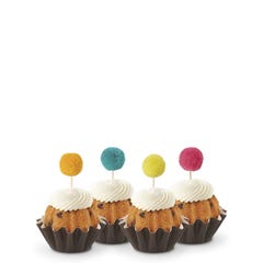 Cupcake sized bundt cakes in Gluten Free Chocolate Chip Cookie flavor with a pom pom topper. 