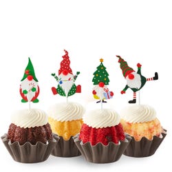Holiday Gnome Bundtinis® topped with frosting and decorated with Christmas themed gnomes.