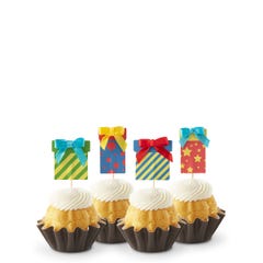 Cupcake-sized mini cakes with frosting and birthday present toppers with different celebratory designs.