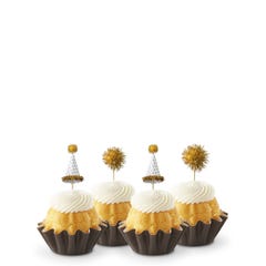 Mini Bundt cakes adorned with festive party hat toppers and golden pom-poms themed for a New Year's celebration.