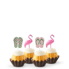 Mini bundt cakes decorated with a topper: from left to right, there's a pair of green tropical flip-flops, a pink flamingo, another pair of pink flip-flops with green straps, and another pink flamingo.