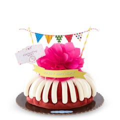 A bundt cake with a banner that says Happy Birthday, with party pennants with various dotted and lined designs. A card reads Cele'bundt'ing YOU!.