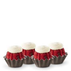 Red Velvet flavored mini bundt cakes topped with a cream cheese frosting swirl.