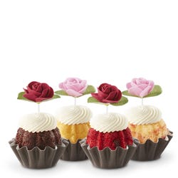 Cupcake sized bundt cakes in a variety of flavors with a pink and red rose toppers