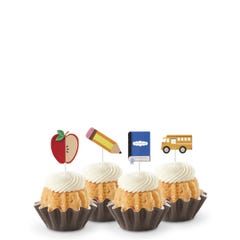 Strawberries & Cream flavored mini Bundt cakes (Bundtinis®) topped with creamy white frosting, accompanied by school-themed toppers: a sliced apple, a pencil, a notebook, and a yellow school bus.