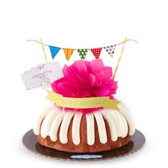 A bundt cake with a banner that says Happy Birthday, with party pennants with various dotted and lined designs. A card reads Cele'bundt'ing YOU!.