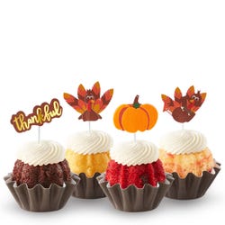 Thankful Turkey Bundtinis® topped with frosting and decorated with pumpkin and turkey toppers as well as a topper with Thankful written in cursive. 