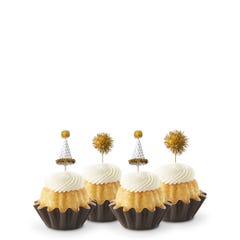 Vanilla Mini Bundt cakes adorned with festive party hat toppers and golden pom-poms themed for a New Year's celebration.